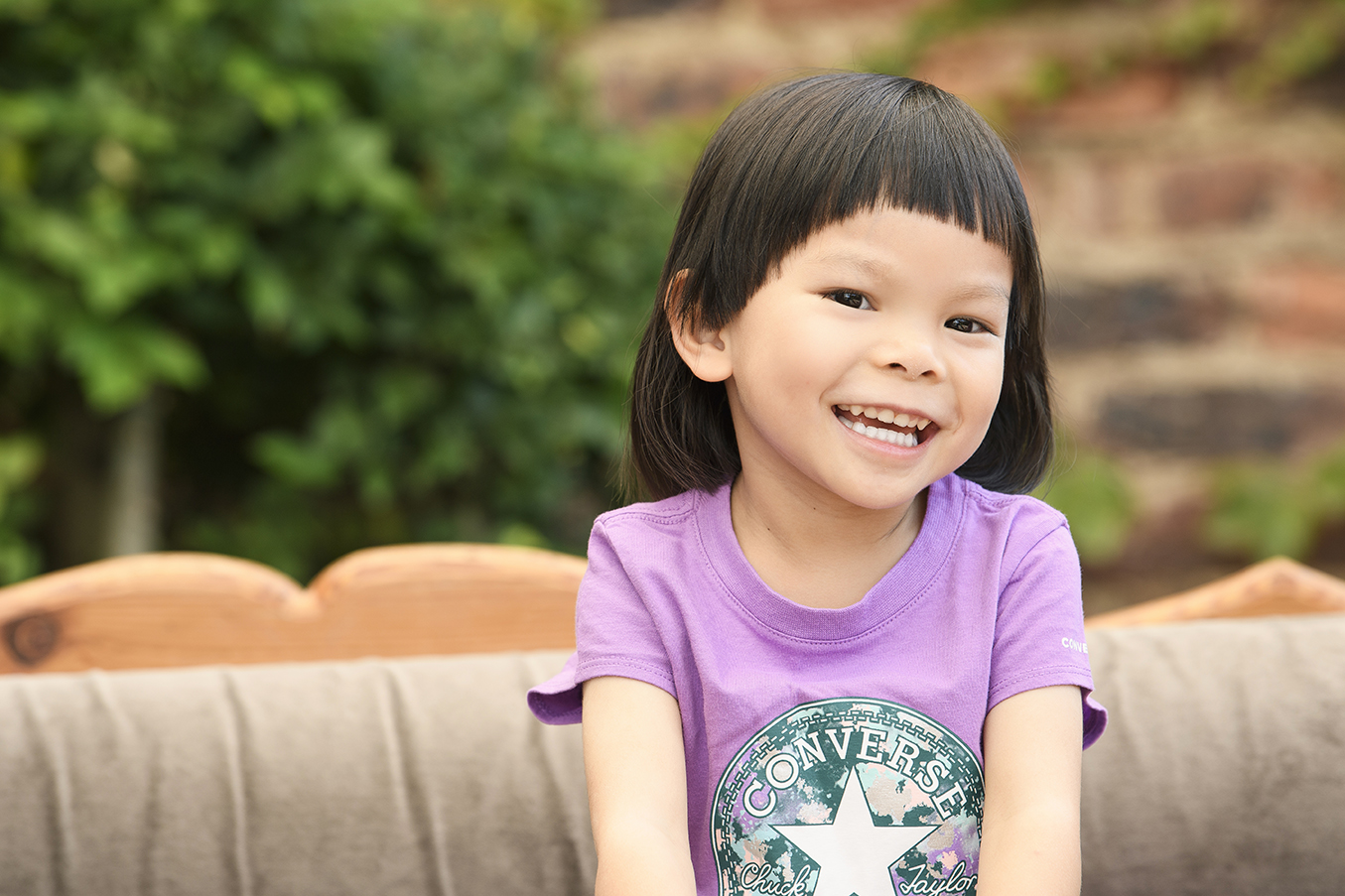 Outdoor/ relaxed/ casual garden setting smiling/ laughing child/kids portrait shot in studio by Kevin Mark Pass Photography